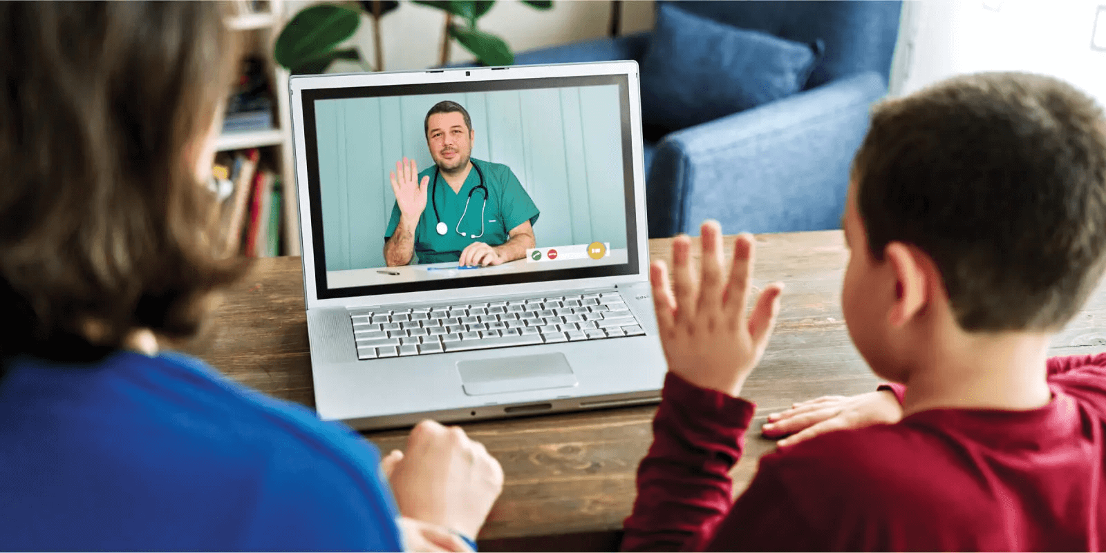 A child and parent interacting with a healthcare worker over the computer